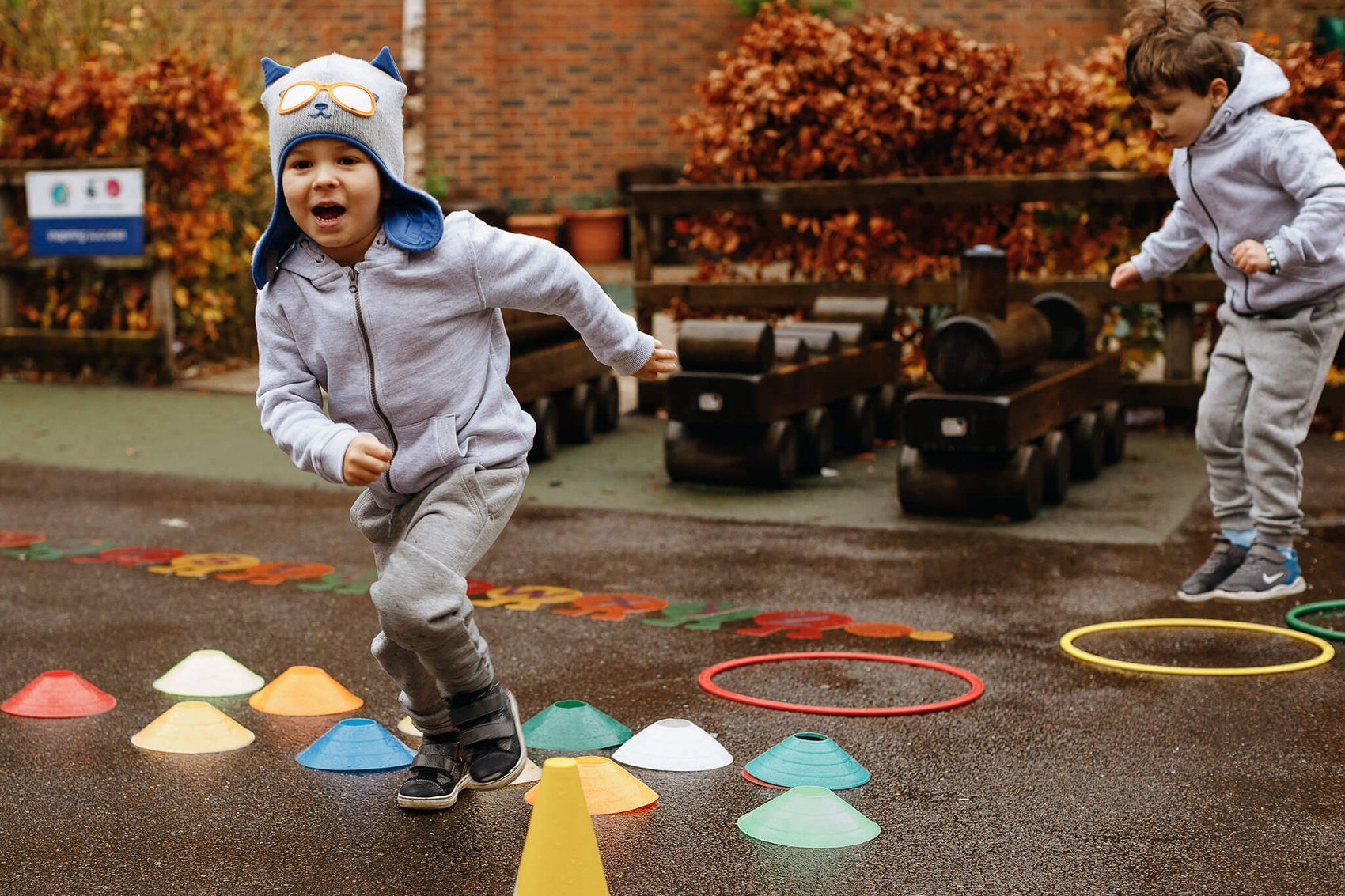 A child running across the playground between coloured cones