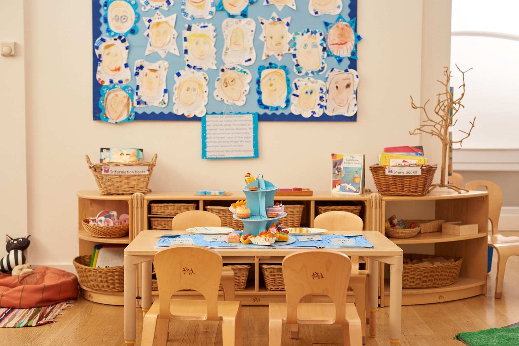 A classroom set out for the morning, with a low table and small chairs